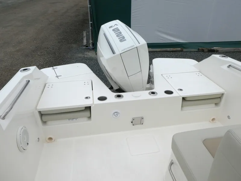 Slide: The Image of 2025 Boston Whaler 210 Vantage boat stern with outboard motor and seating area. - 6