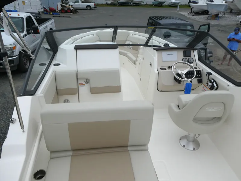 Slide: The Image of 2025 Boston Whaler 210 Vantage boat interior with seating and steering console. - 7