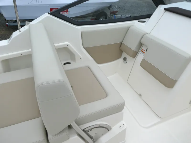 Slide: The Image of 2025 Boston Whaler 210 Vantage interior seating with beige and white upholstery. - 9