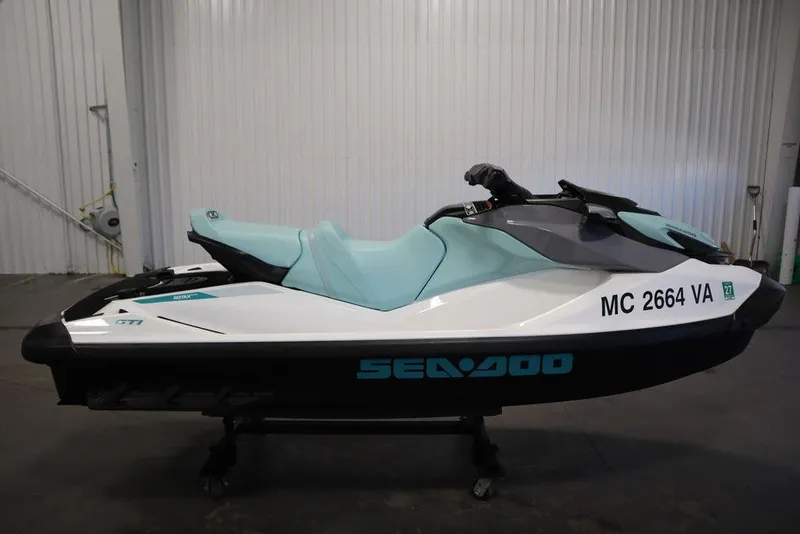 Slide: The Image of 2024 Sea-Doo GTI™ 130 jet ski in a garage setting, side view. - 10