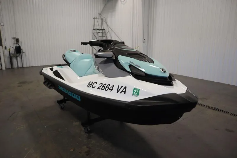 Slide: The Image of 2024 Sea-Doo GTI™ 130 jet ski in a garage, featuring sleek design and mint accents. - 11