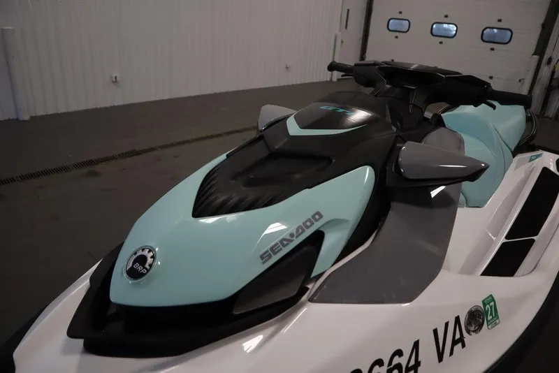 Slide: The Image of 2024 Sea-Doo GTI™ 130 jet ski in a showroom, showcasing sleek design and modern features. - 5
