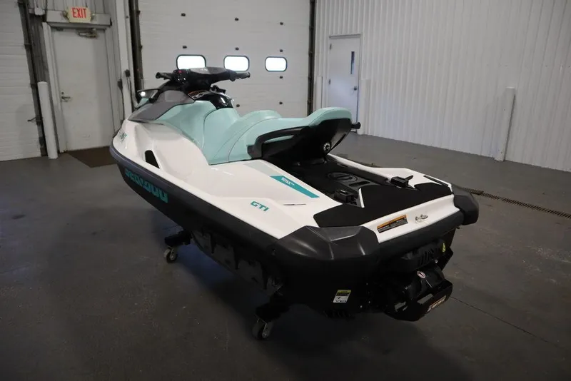 Slide: The Image of 2024 Sea-Doo GTI™ 130 jet ski in a garage, showcasing sleek design and mint green seat. - 6