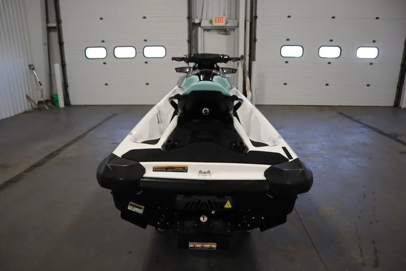 Slide: The Image of 2024 Sea-Doo GTI™ 130 jet ski in a garage, rear view. - 8