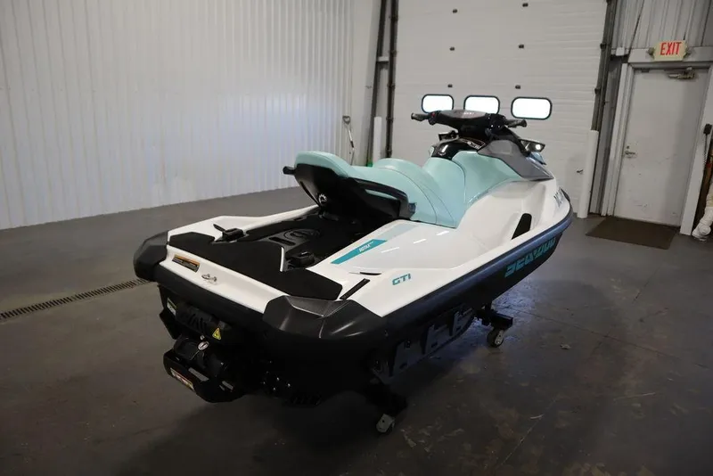 Slide: The Image of 2024 Sea-Doo GTI™ 130 jet ski in a garage, showcasing sleek design and mint green seat. - 9