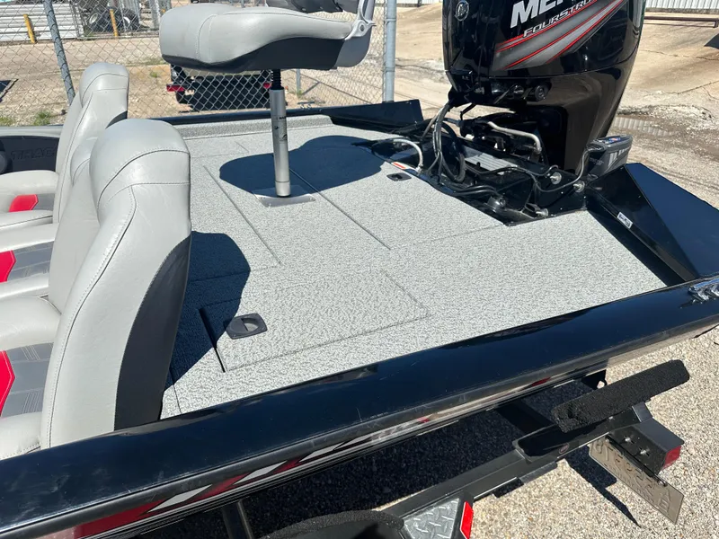 Slide: The Image of 2017 Tracker Pro Team 175 TXW boat with seating and motor, parked outdoors. - 10