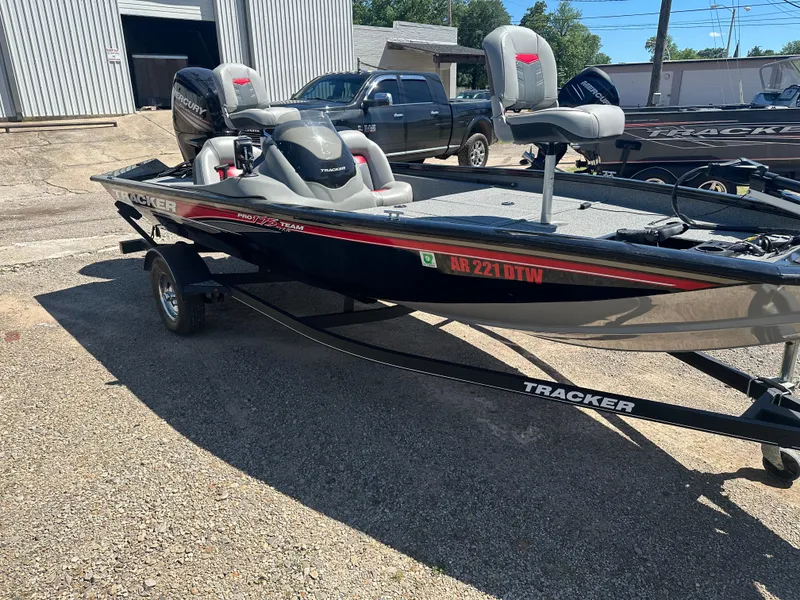 Slide: The Image of 2017 Tracker Pro Team 175 TXW boat on trailer, parked outdoors. - 2
