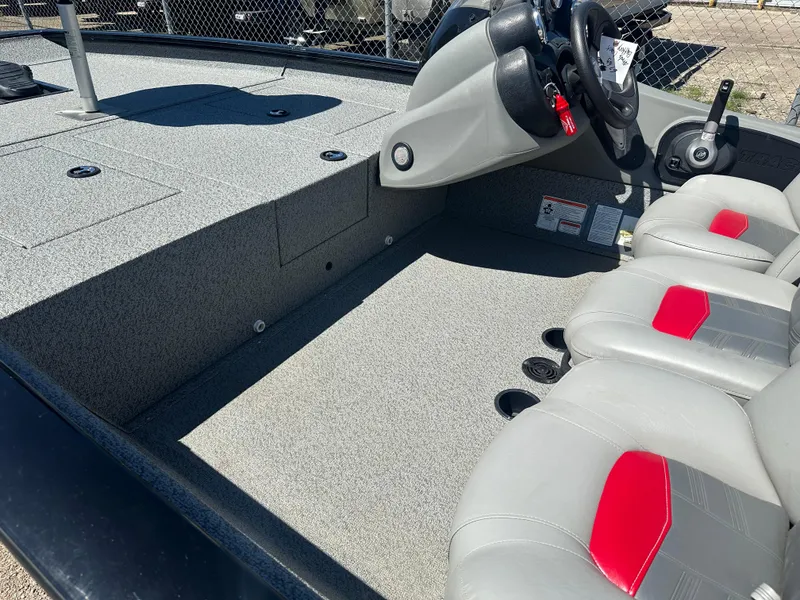 Slide: The Image of 2017 Tracker Pro Team 175 TXW boat interior with gray and red seating. - 9