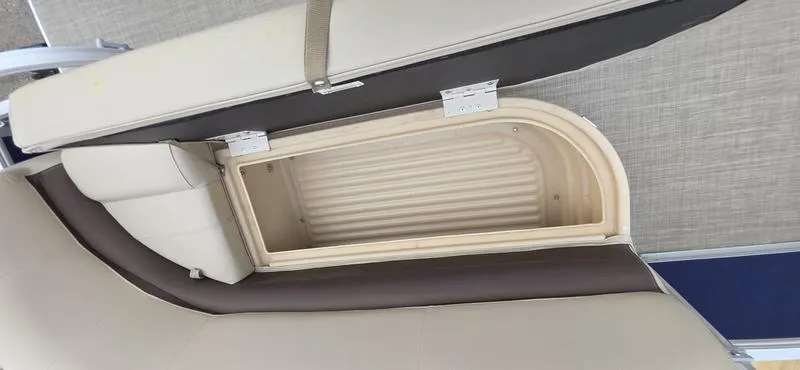 Slide: The Image of 2017 Sun Tracker Party Barge 18 DLX storage compartment with open cushioned seat. - 16