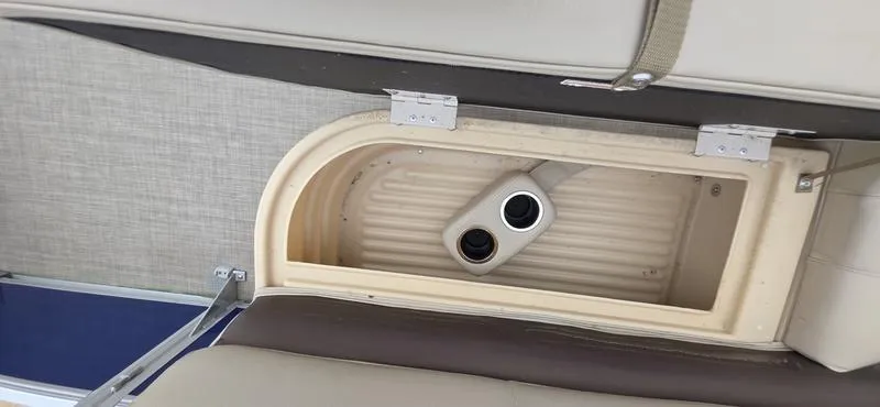 Slide: The Image of 2017 Sun Tracker Party Barge 18 DLX storage compartment with cup holders. - 17