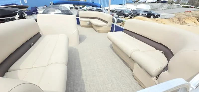 Slide: The Image of 2017 Sun Tracker Party Barge 18 DLX interior with spacious seating and beige upholstery. - 4