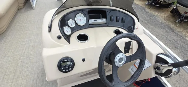 Slide: The Image of 2017 Sun Tracker Party Barge 18 DLX dashboard with steering wheel and gauges. - 7