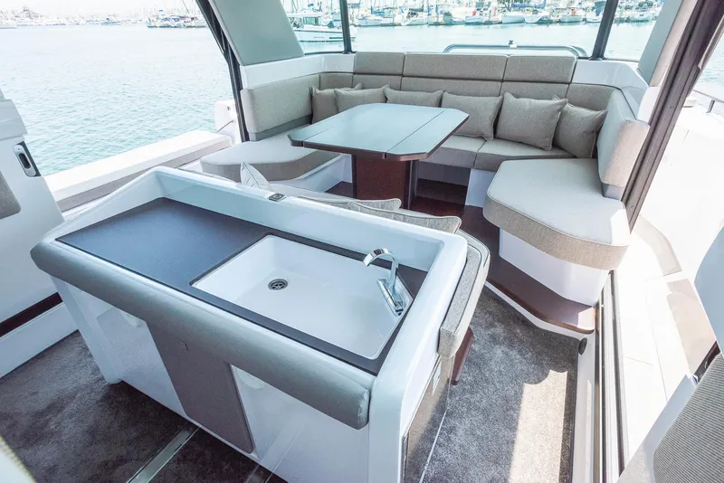 Slide: The Image of 2025 Axopar 45 XC Cross Cabin interior with modern seating and kitchenette. - 28