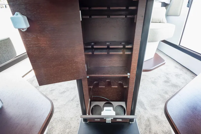 Slide: The Image of 2025 Axopar 45 XC Cross Cabin interior storage compartment with wooden finish. - 30