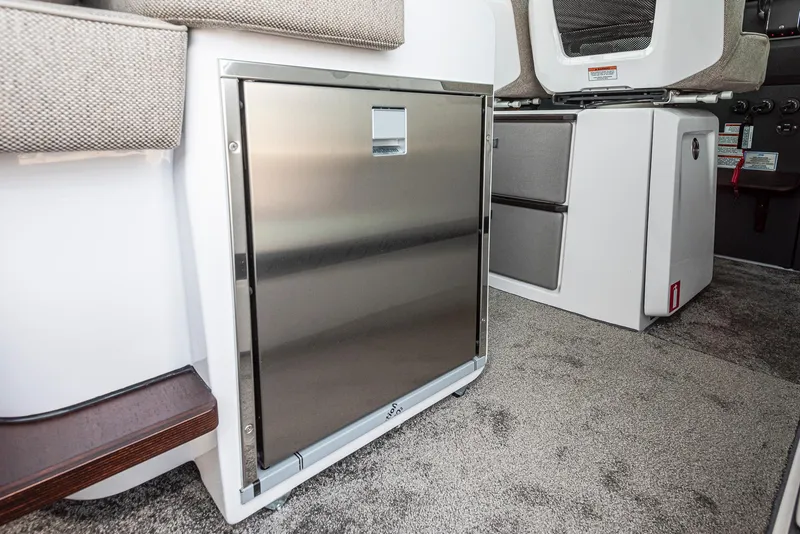 Slide: The Image of 2025 Axopar 45 XC Cross Cabin interior with stainless steel fridge and modern design. - 31