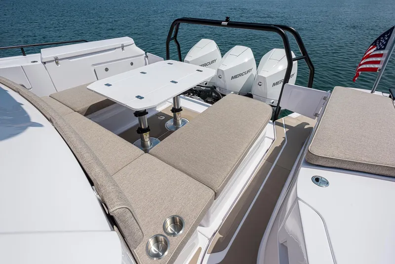 Slide: The Image of 2025 Axopar 45 XC Cross Cabin with seating area and triple Mercury engines. - 32