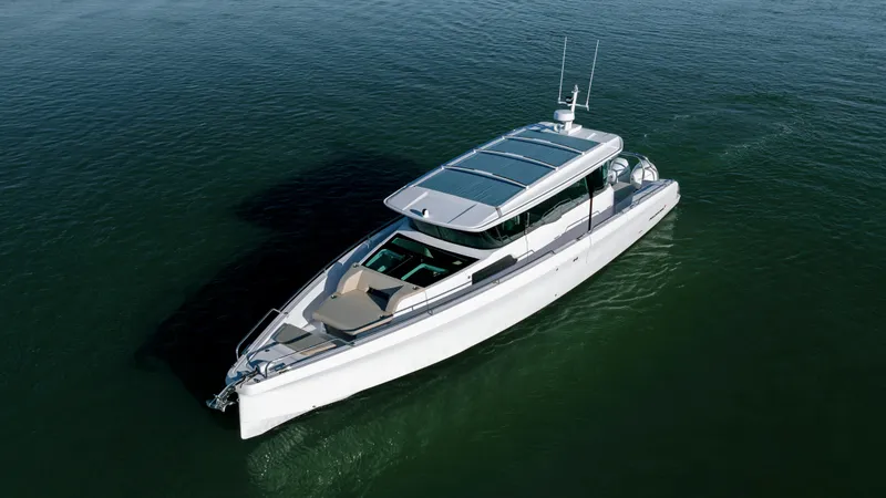 Slide: The Image of 2025 Axopar 45 XC Cross Cabin boat cruising on calm waters. - 4