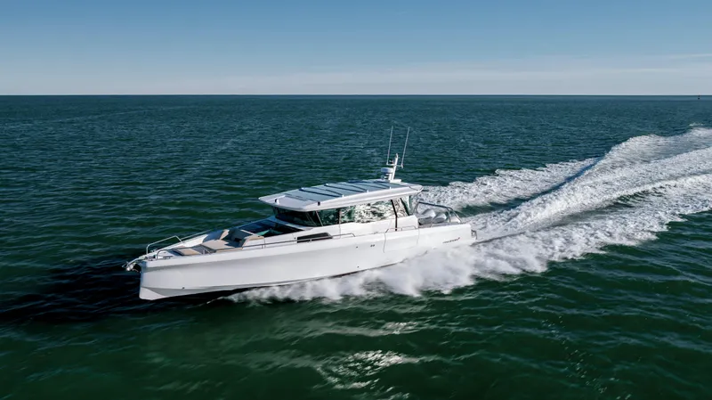 Slide: The Image of 2025 Axopar 45 XC Cross Cabin cruising on open water, showcasing sleek design and performance. - 7