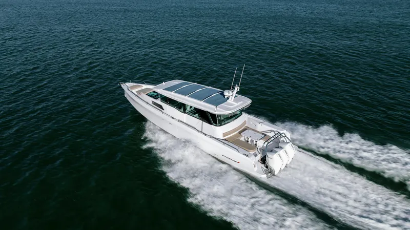 Slide: The Image of 2025 Axopar 45 XC Cross Cabin cruising on open water. - 9