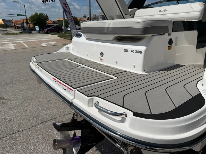 Slide: The Image of Rear view of a Sea Ray SLX 260 boat with gray decking and stainless steel details. - 20