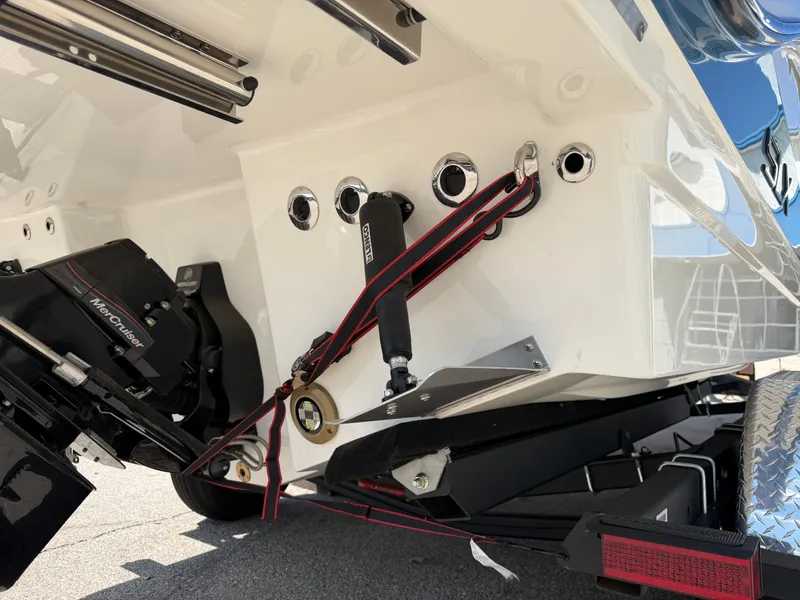 Slide: The Image of The image shows the stern of a Sea Ray SLX 260 boat with motor and trailer. - 13