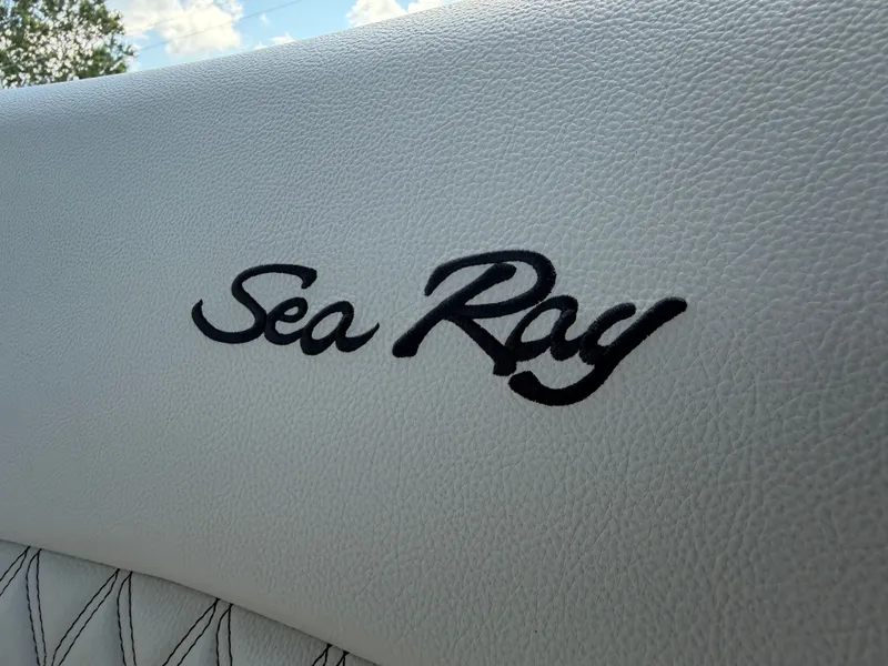 Slide: The Image of Sea Ray logo on white upholstery with quilted pattern. - 44