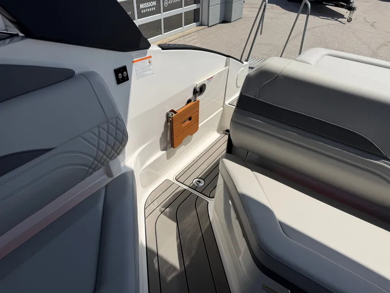 Slide: The Image of Interior of a Sea Ray SLX 260 boat with gray and white seating and wood flooring. - 32