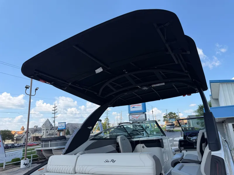 Slide: The Image of The image shows a 2026 Sea Ray SLX 260 boat with a large black sunshade. - 43