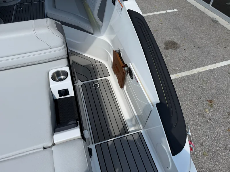 Slide: The Image of The image shows the stern of a Sea Ray SLX 260 boat with gray and white upholstery. - 30