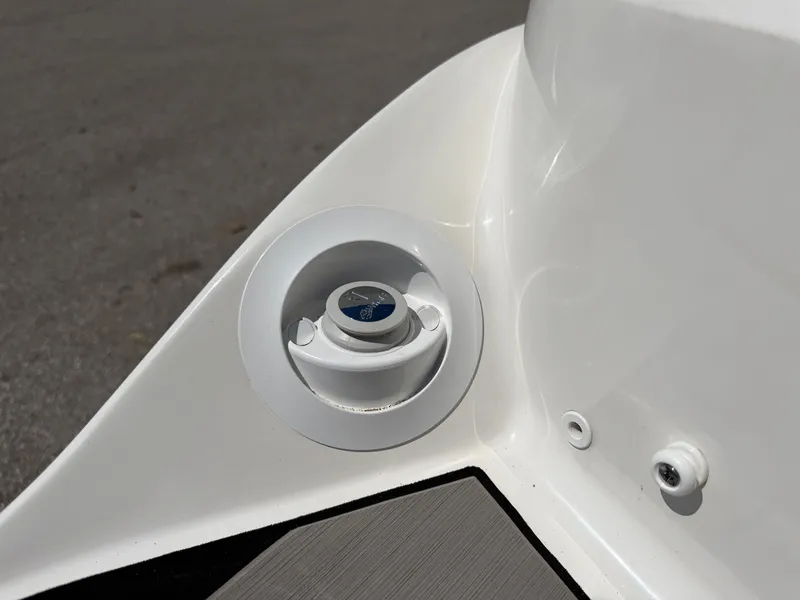 Slide: The Image of Close-up of a boat deck detail with a round, white inlet and a blue symbol. - 23