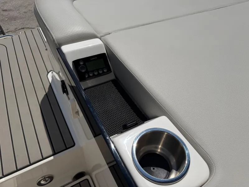 Slide: The Image of 2026 Sea Ray SLX 260 with gray upholstery, cup holder, and control panel. - 25