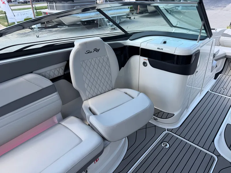 Slide: The Image of The image shows the cockpit of a Sea Ray SLX 260 boat with sleek, upholstered seating. - 39