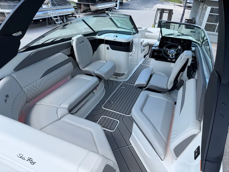 Slide: The Image of Interior of a Sea Ray SLX 260 boat with luxurious white seating and a modern helm. - 41