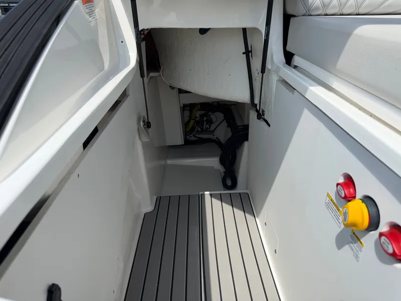 Slide: The Image of Interior of a 2026 Sea Ray SLX 260 boat with gray flooring and white walls. - 29