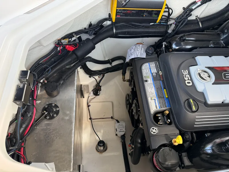 Slide: The Image of Engine compartment of a Sea Ray SLX 260 with a 350 HP engine and electronic components. - 47