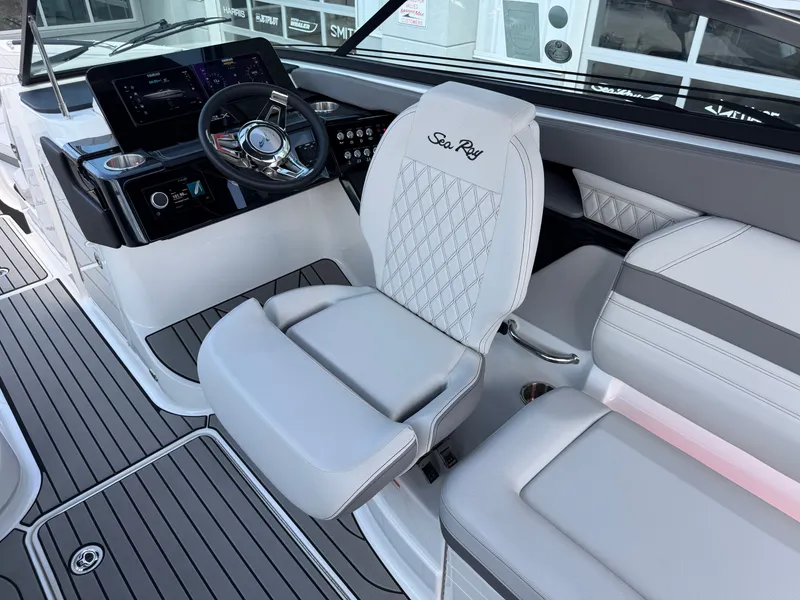 Slide: The Image of The image shows the helm of a 2026 Sea Ray SLX 260 boat with luxurious white seating. - 40