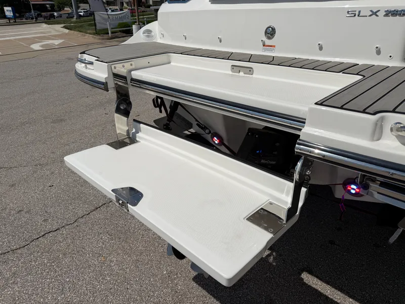 Slide: The Image of Aft section of a 2026 Sea Ray SLX 260 with a fold-out swim platform. - 21