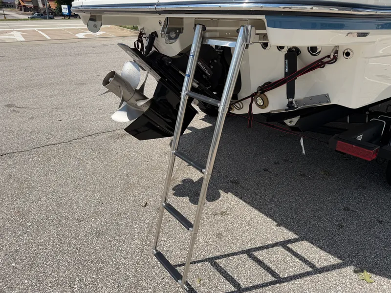 Slide: The Image of A 2026 Sea Ray SLX 260 with a retractable swim ladder at the stern. - 19
