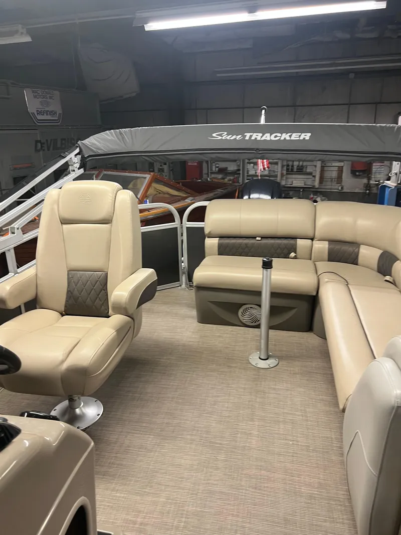 Slide: The Image of 2020 Sun Tracker Party Barge 20 DLX interior with beige seating and canopy. - 3