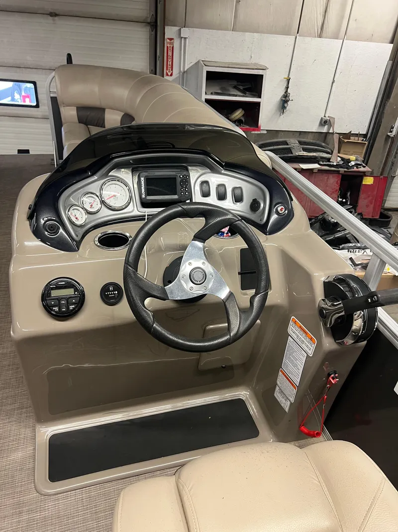 Slide: The Image of 2020 Sun Tracker Party Barge 20 DLX helm with steering wheel and control panel. - 4