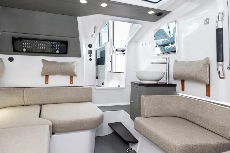 Slide: The Image of Luxurious interior of 2023 Axopar 37 XC Cross Cabin with modern seating and wet bar. - 18