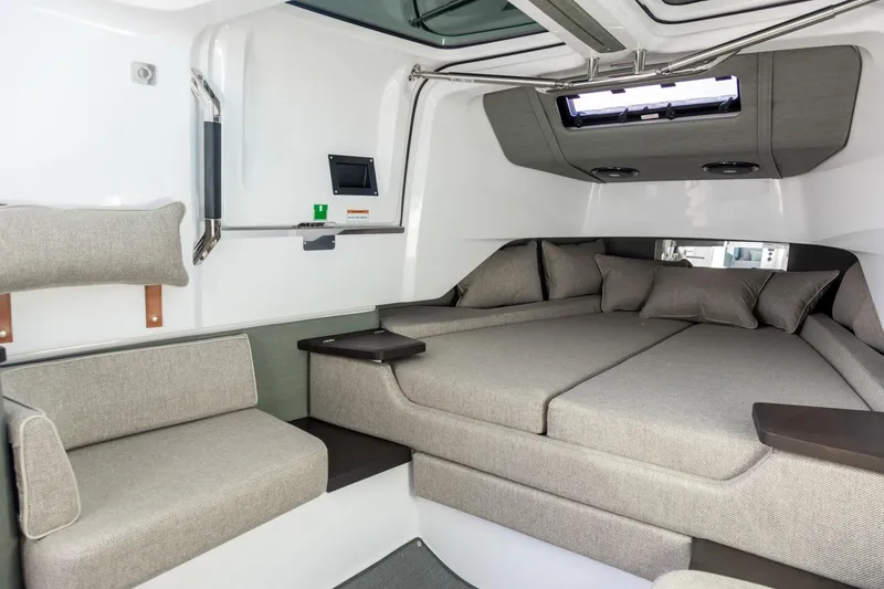 Slide: The Image of 2023 Axopar 37 XC Cross Cabin interior with Brabus trim, featuring a cozy seating area. - 21
