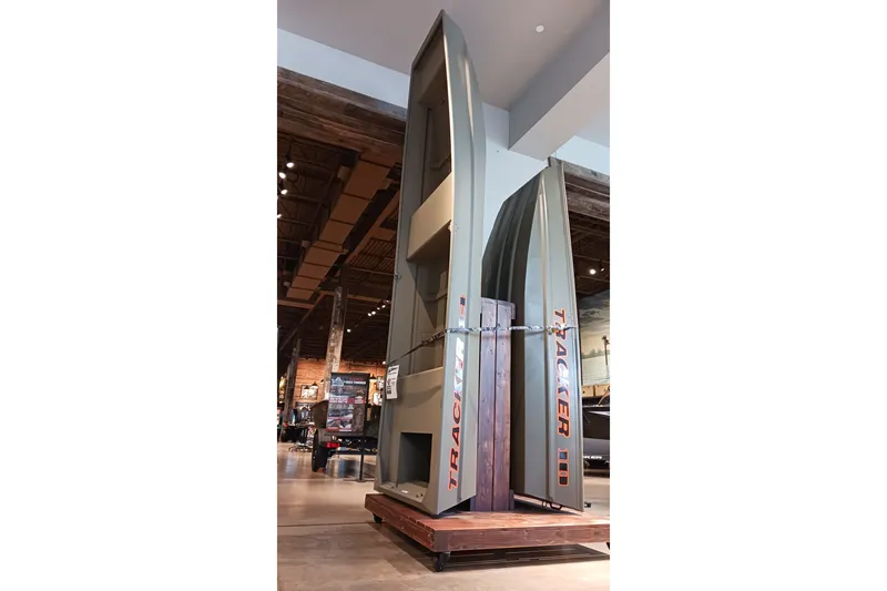 The Image of 2025 Tracker Grizzly 14 Jon boat displayed vertically in a showroom. - 0