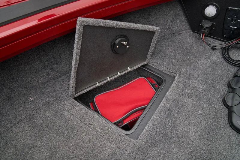 Slide: The Image of 2025 Tracker Targa V-19 Combo boat interior with open storage compartment. - 25