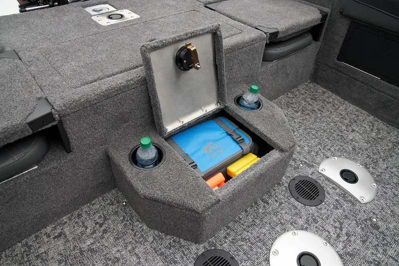 Slide: The Image of 2025 Tracker Targa V-19 Combo interior storage compartment with carpeted finish. - 56