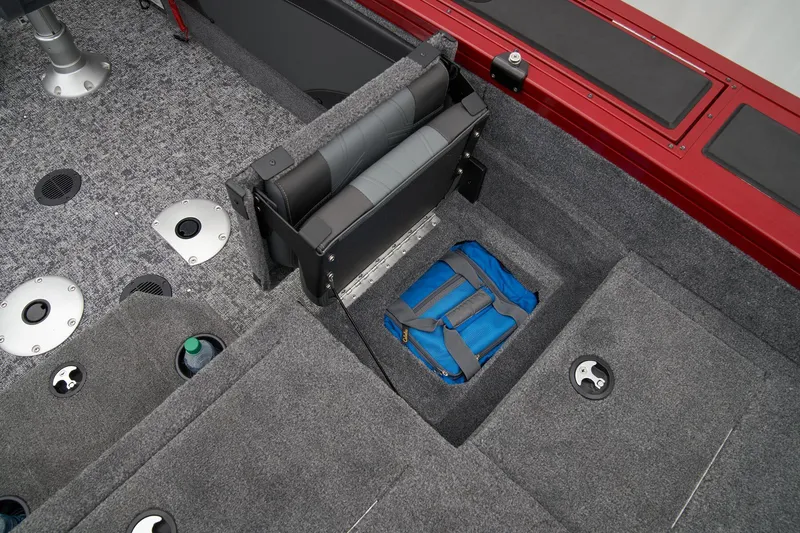 Slide: The Image of 2025 Tracker Targa V-19 Combo boat storage compartment with tackle boxes. - 57