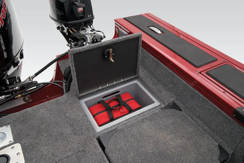 Slide: The Image of 2025 Tracker Targa V-19 Combo boat interior under seat storage compartment with gray carpet. - 59