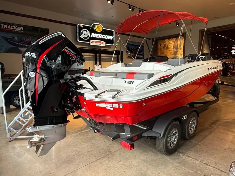 Slide: The Image of 2025 Tahoe T21 boat with Mercury engine, red and white design, displayed indoors. - 3
