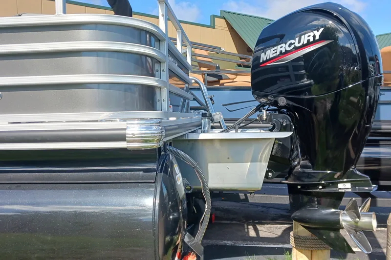 Slide: The Image of 2025 Ranger Reata 220FC pontoon boat with Mercury outboard motor, docked outdoors. - 3