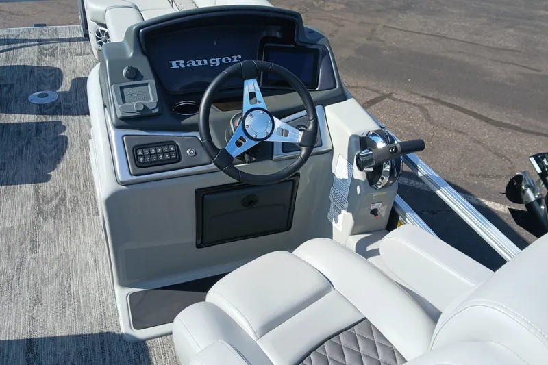 Slide: The Image of 2025 Ranger Reata 220FC boat dashboard with steering wheel and controls. - 8